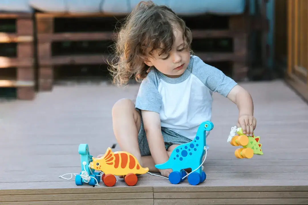 dzieci 3-5 lat bawiące się zabawkami dinozaurami